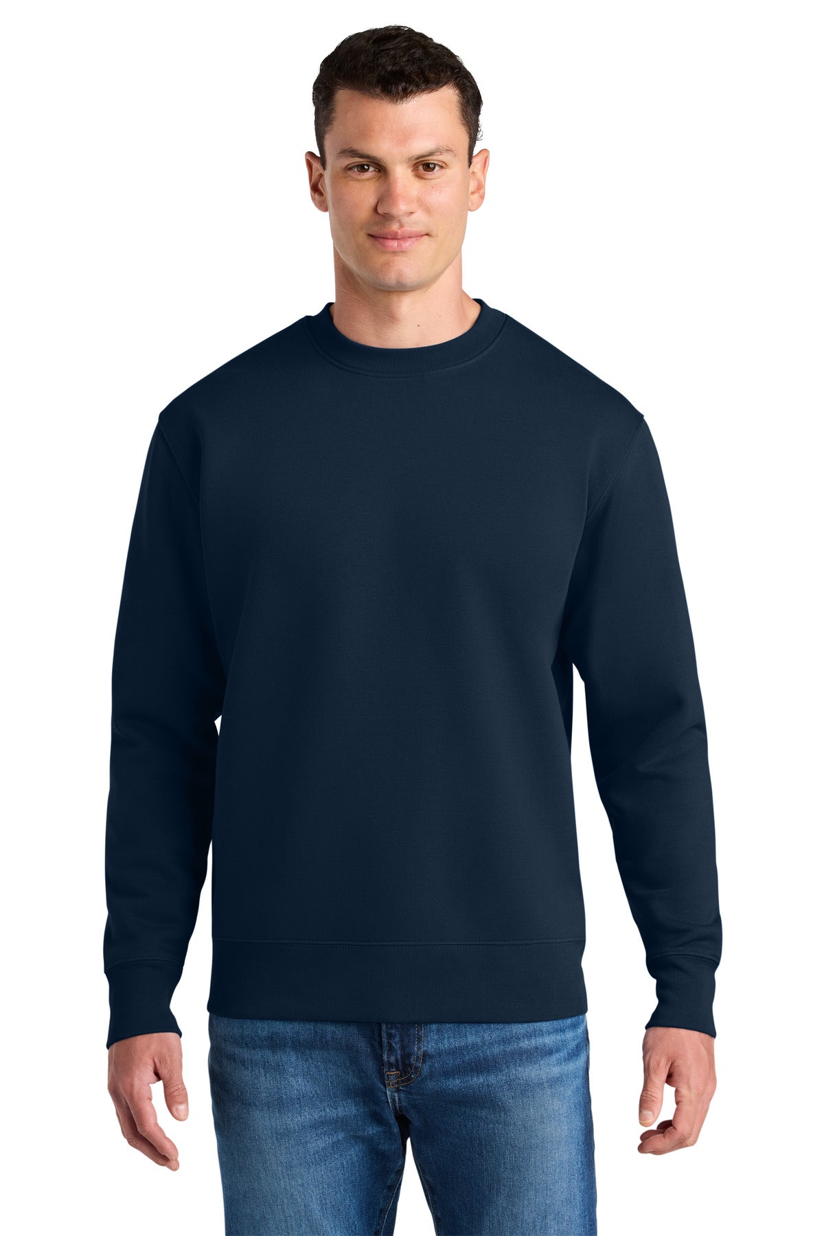Man wearing a navy blue sweatshirt and jeans on a white background