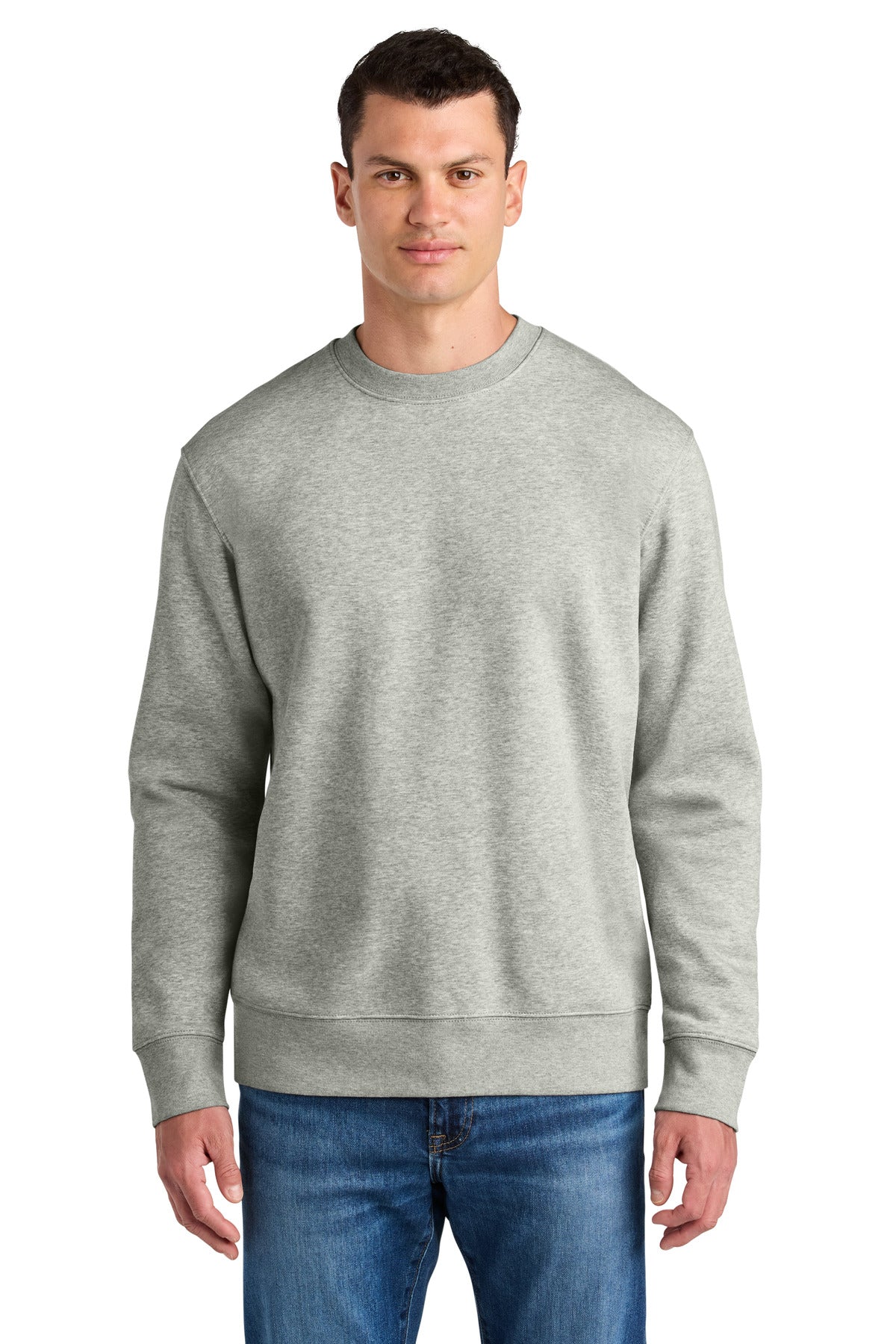 Man wearing a gray sweatshirt and blue jeans on a white background