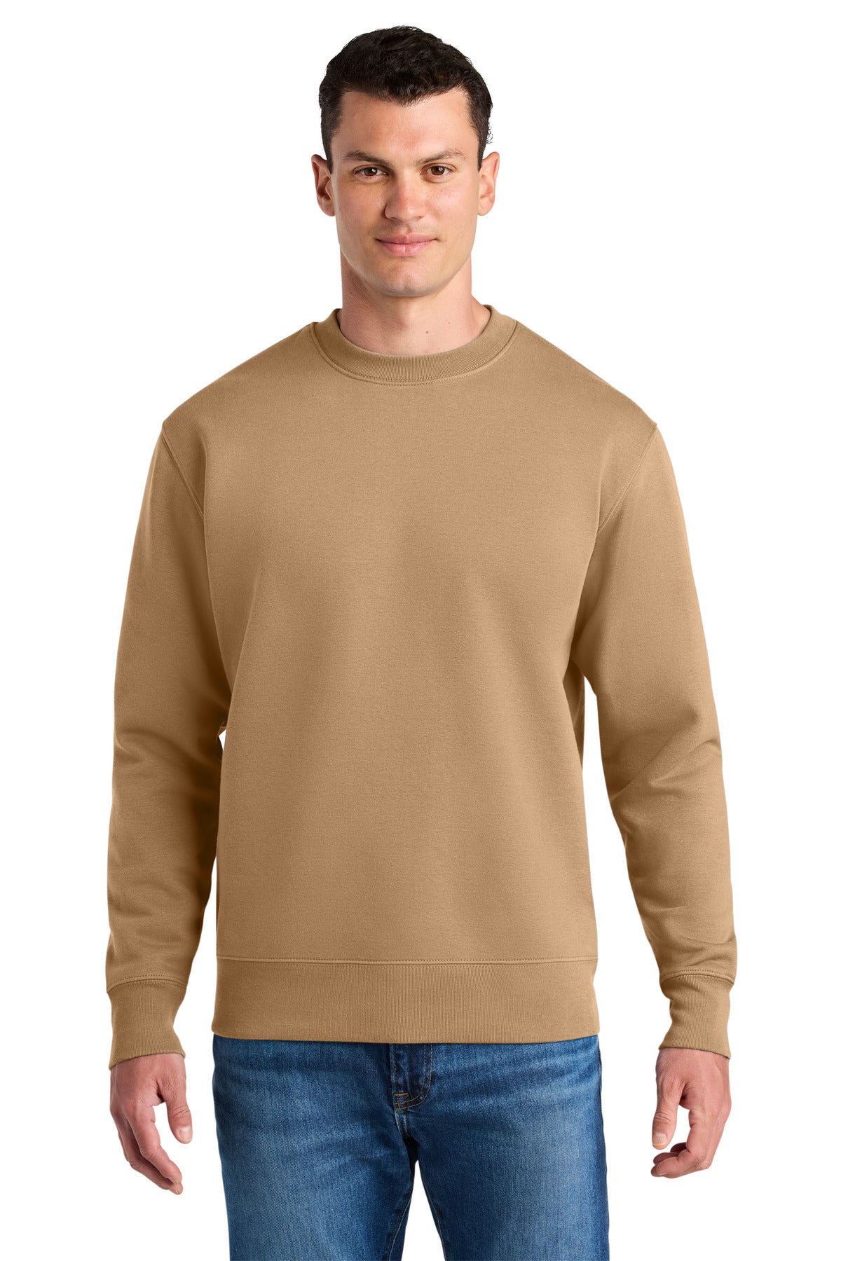 Man wearing a beige sweatshirt and blue jeans on a white background