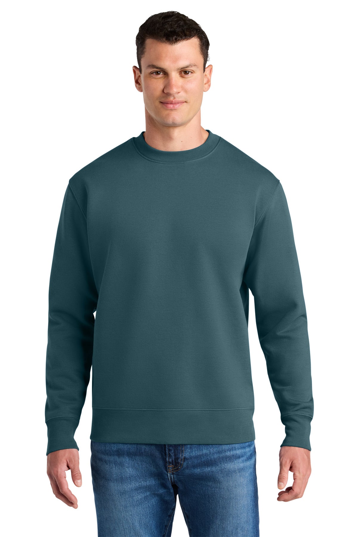 Man wearing a teal sweatshirt and blue jeans on a white background